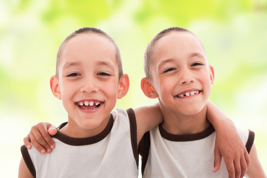 Two smiling happy boys twins